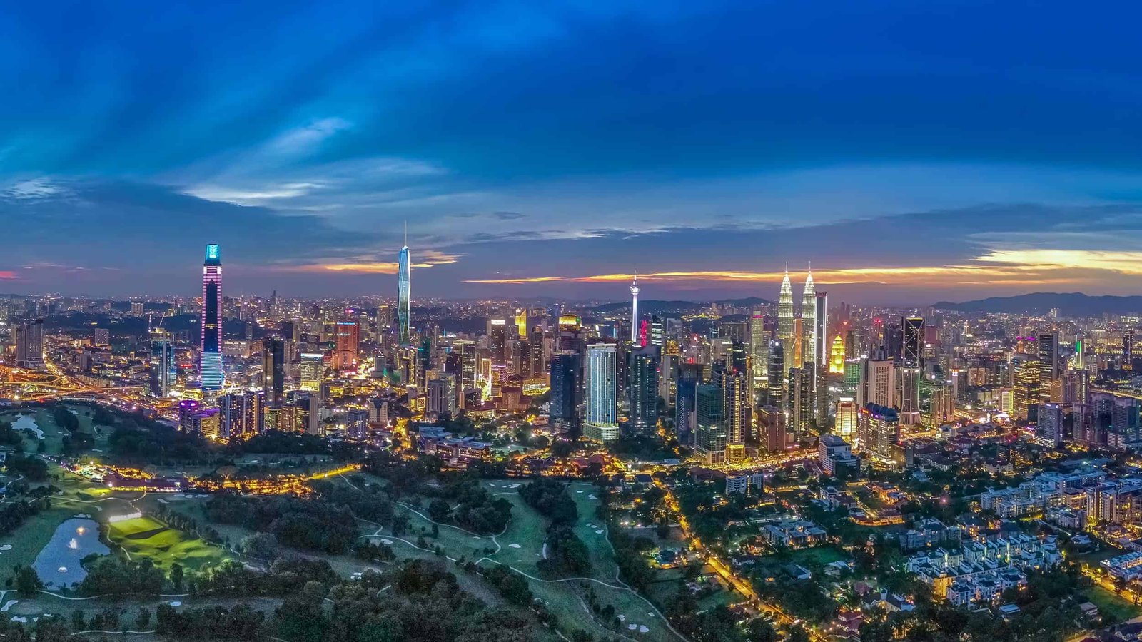 Aerial view of Eaton Residences @ KLCC between the Petronas Twin Towers and the Royal Selangor Golf Club