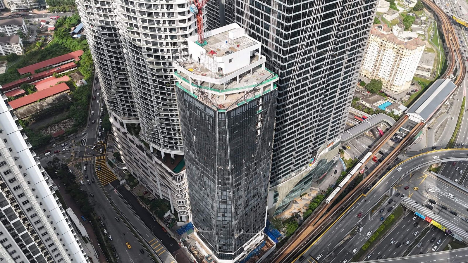 Solarvest Suites construction progress photograph as at June 2026, showing the topped-out tower in Bangsar South, Kuala Lumpur