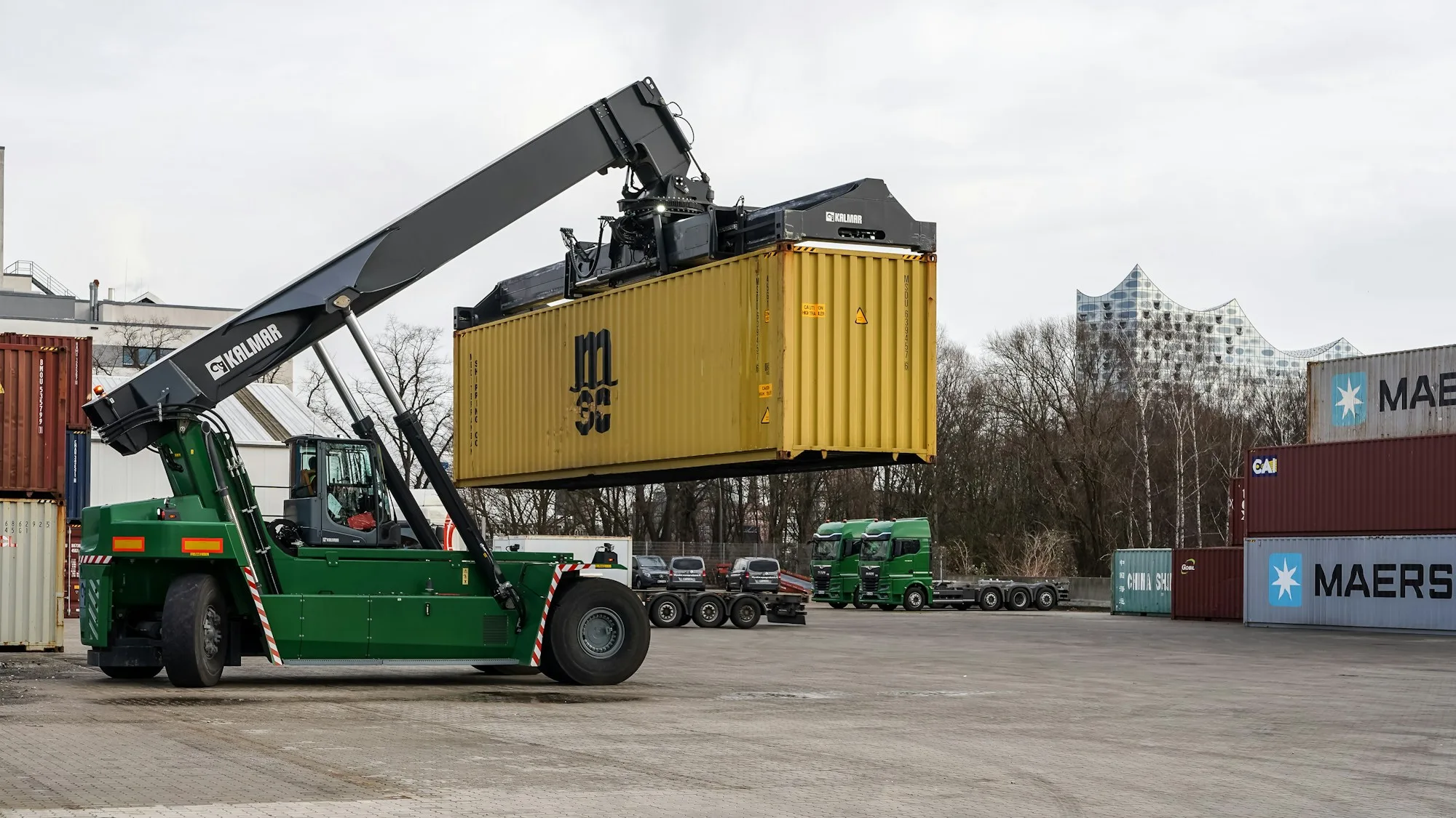 Container depot and reach stacker, representing the open yards and depot uses of the Masai belt