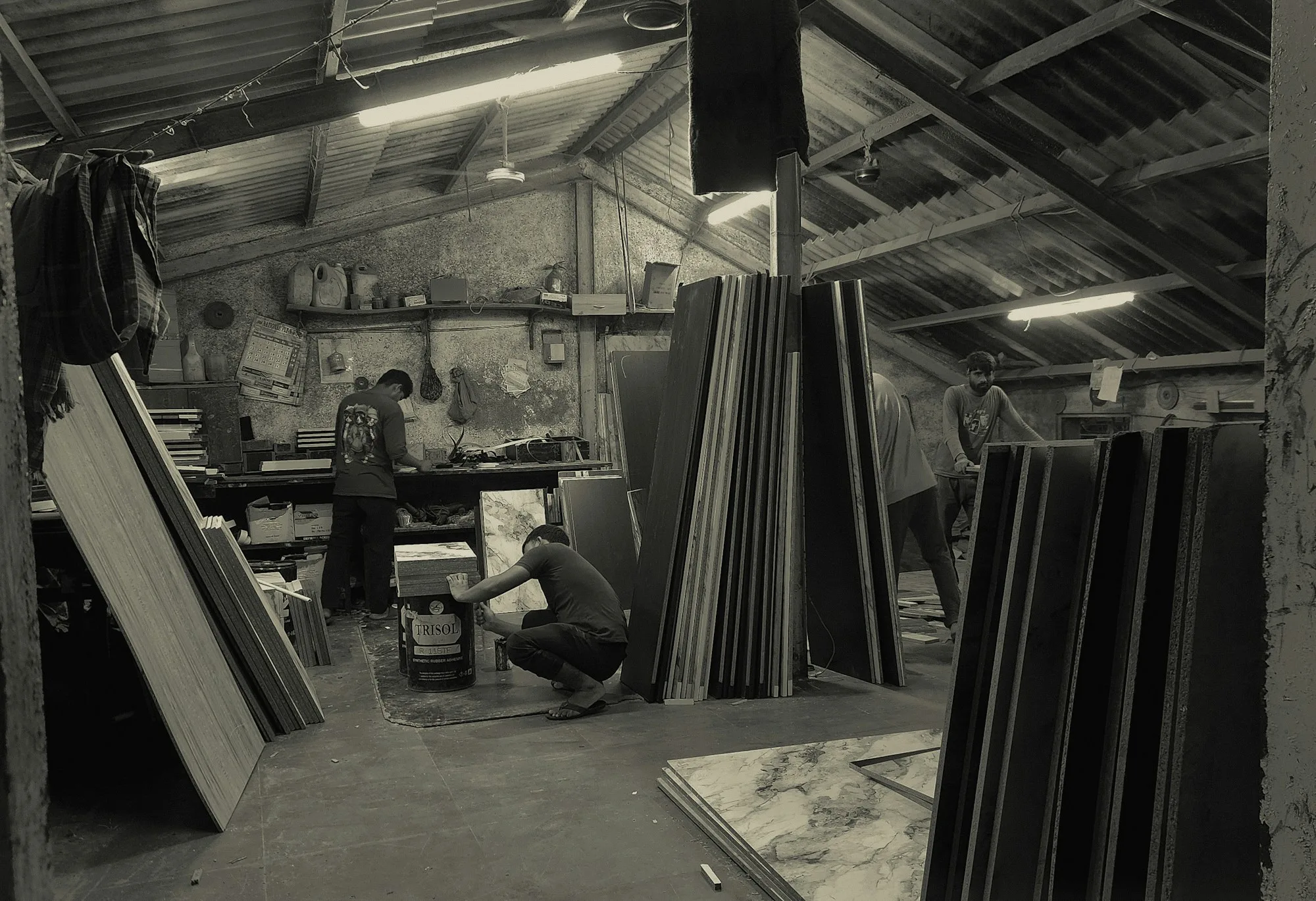 Board cutting and stacking inside a small workshop, representing the SME light industry of the Tebrau belt