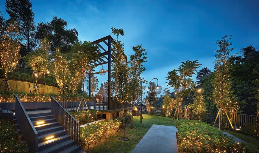 Alila 2 terrace garden and feature walkway lit at dusk, Tanjung Bungah, Penang — actual photo