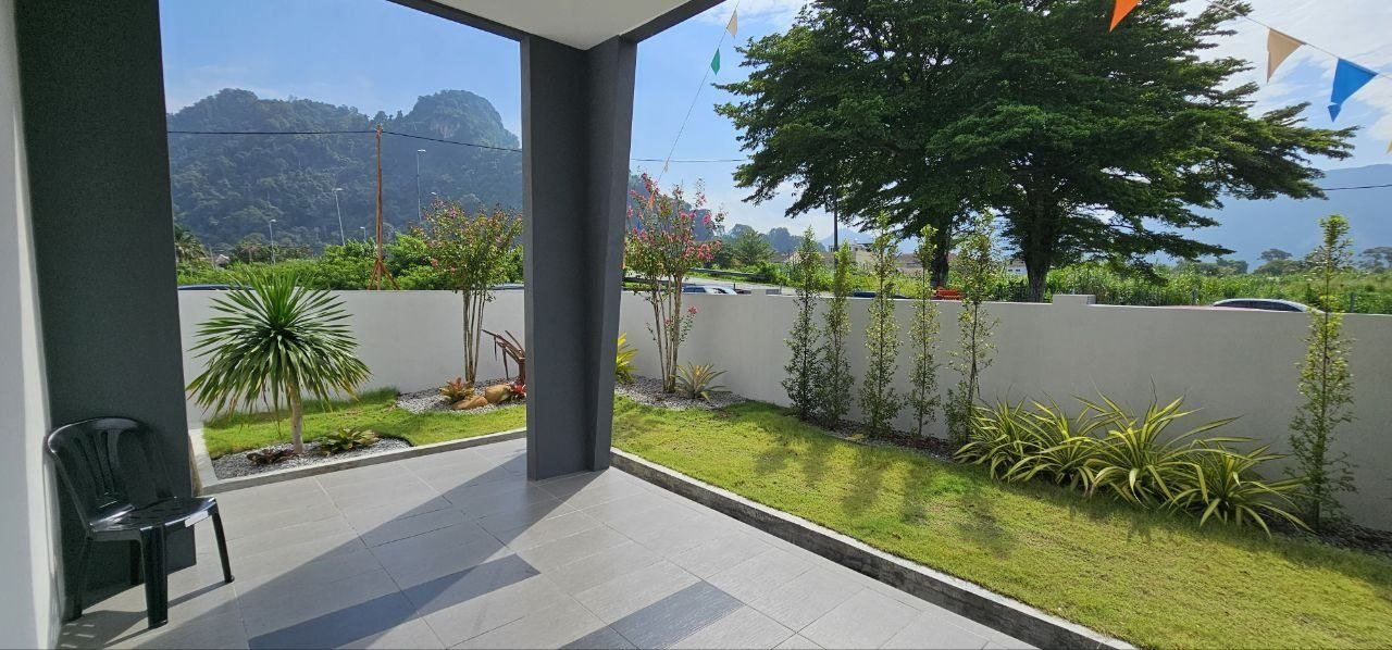 Side garden of the corner terrace show unit facing limestone hills at Ampang Cove by LYS Realty Sdn Bhd, Ampang, Ipoh, Perak