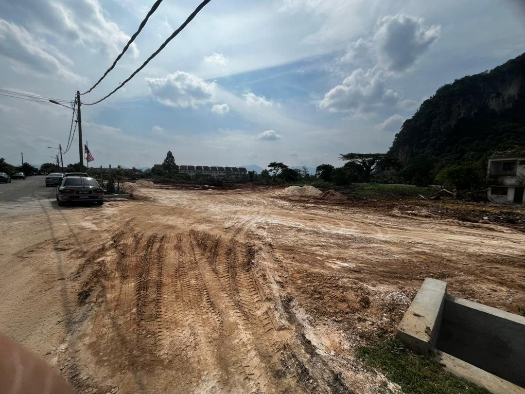 Cleared site of Arena Perpaduan Utama with limestone hills behind, Tambun, Ipoh, Perak