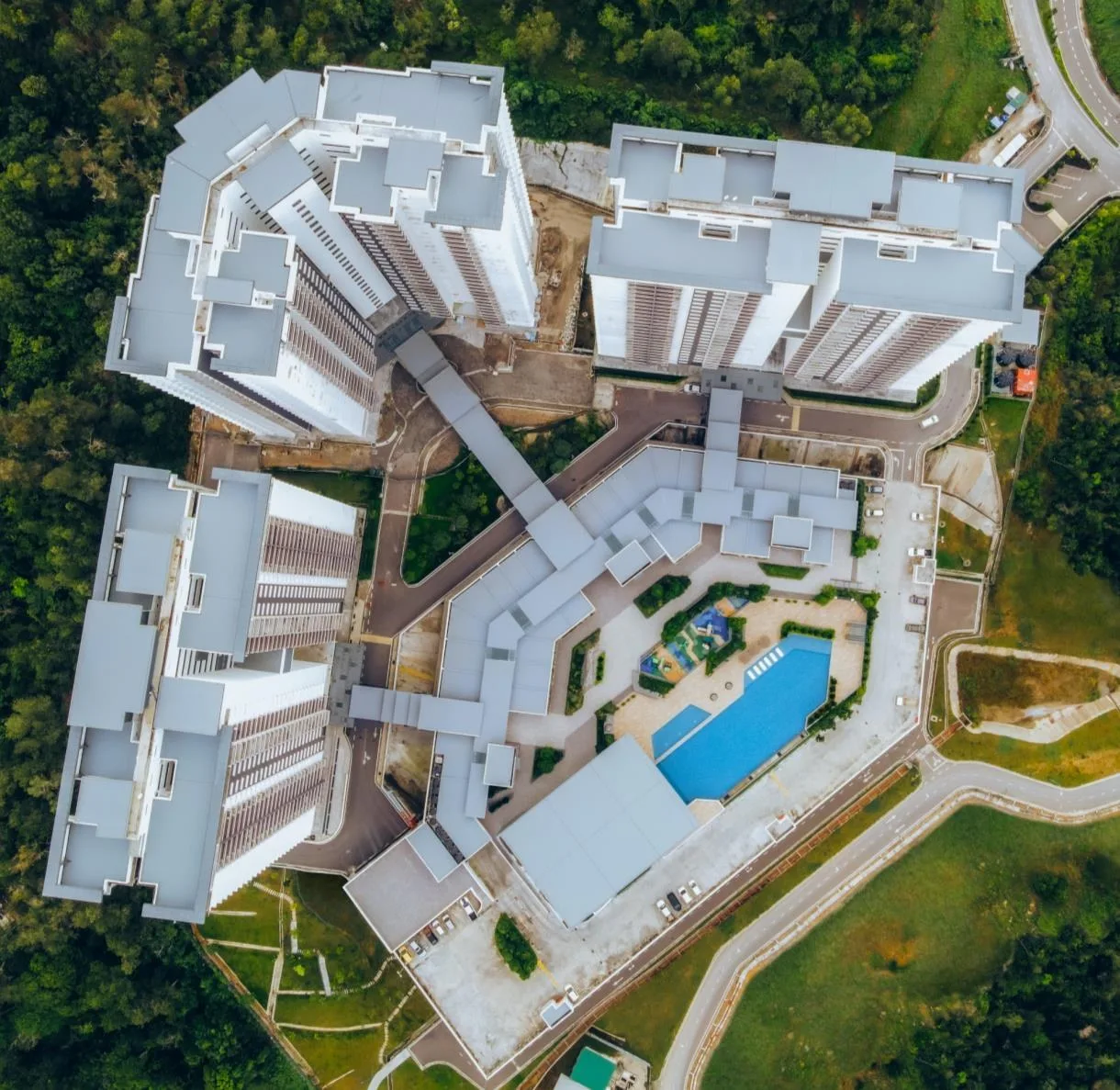 Top-down aerial view: the three blocks around the Curve 25 shops and the pool deck, from the developer’s brochure at Bukit Bantayan Residences, Inanam, Kota Kinabalu, Sabah