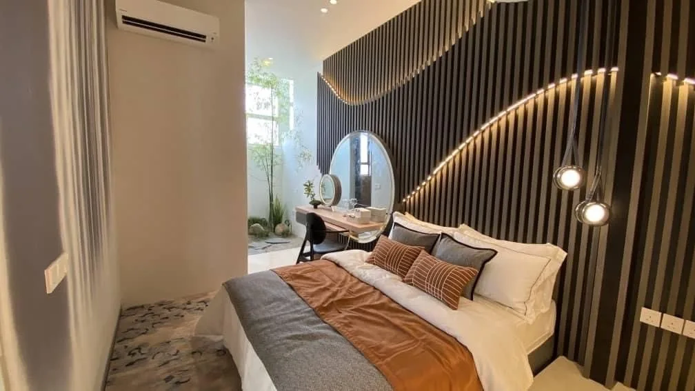 Bedroom with timber feature wall in the Jia @ Ipoh South show house by Team Keris, Ipoh, Perak