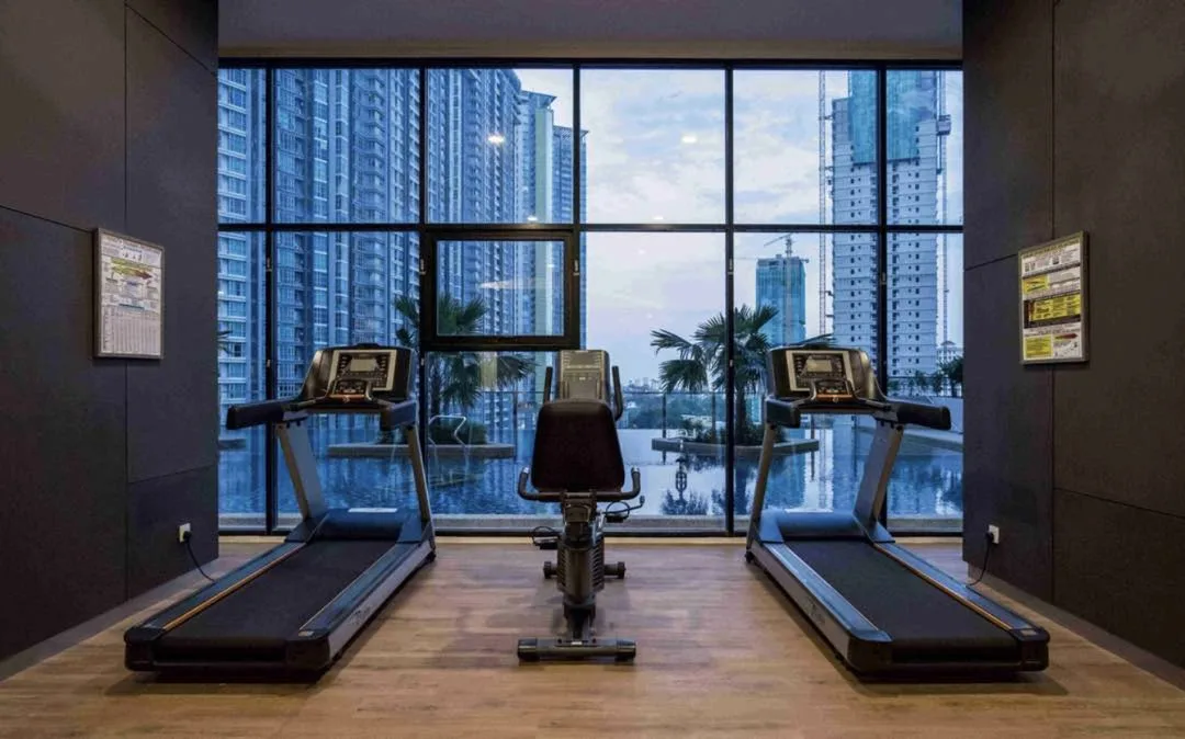 Mont Residence gymnasium with treadmills facing the pool, Tanjung Tokong, Penang