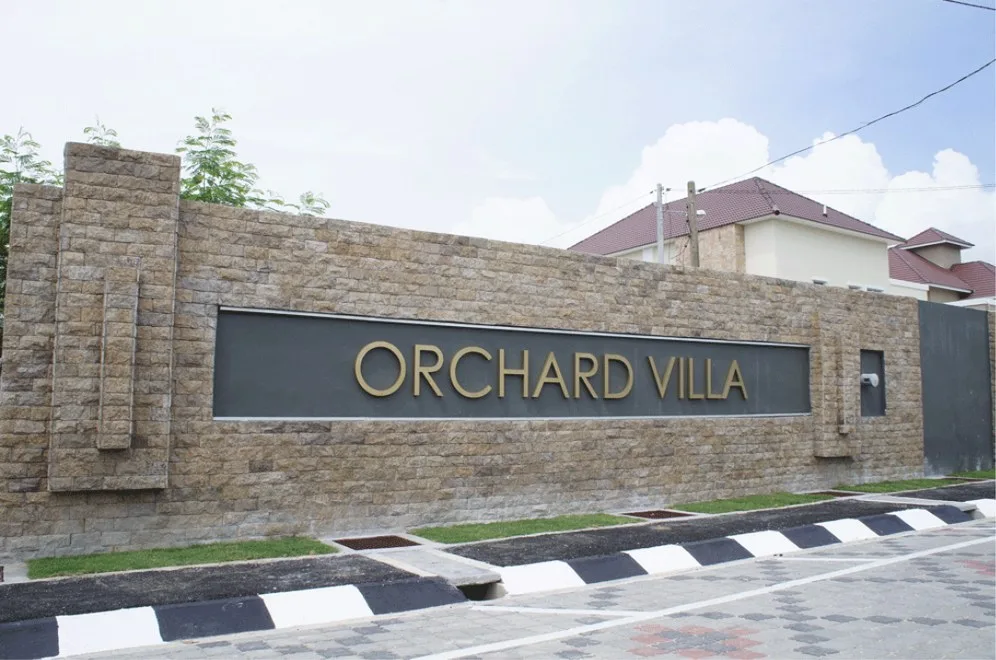 Orchard Villa stone entrance wall with the estate's name, photographed by the developer in 2013, Simpang Ampat, Penang