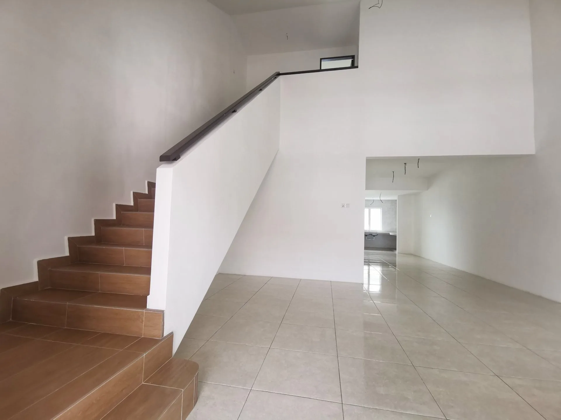 Living area and staircase inside a completed 1.5-storey terrace house at Pearl Garden Phase 2A, Ipoh
