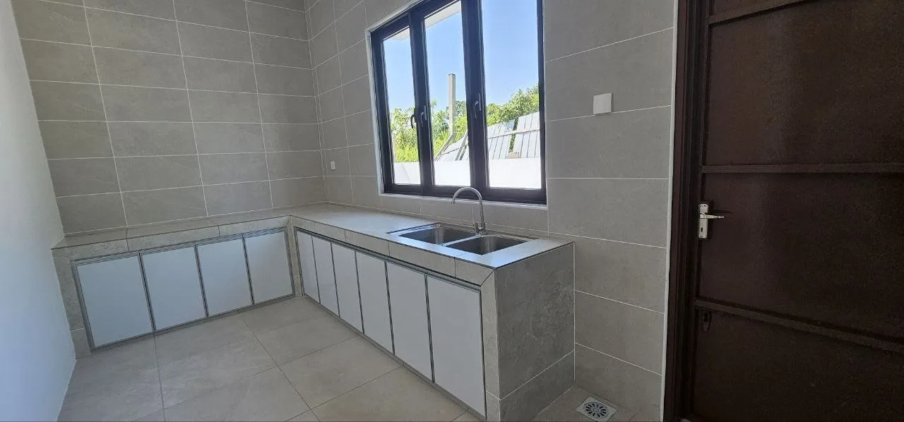Wet kitchen with sink cabinets in the Pinggiran Pengkalan Bayu semi-D show house, Ipoh