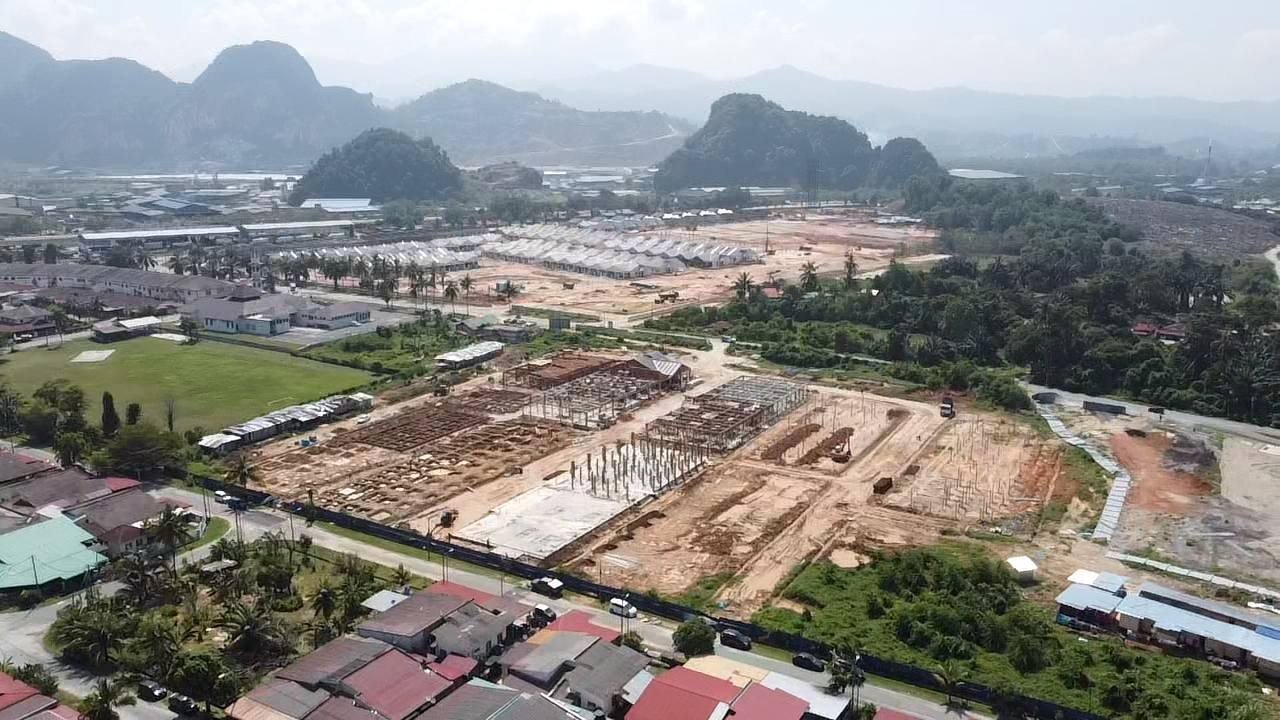 Aerial view of Raia Saujana III construction site with limestone hills behind, Kampung Kepayang, Simpang Pulai, Ipoh, Perak