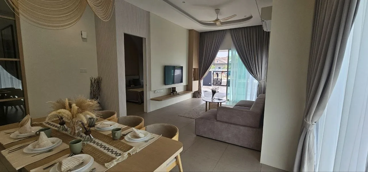 Dining area looking to the living room in the Rimbayu Tanjung Rambutan cluster show house, Ipoh