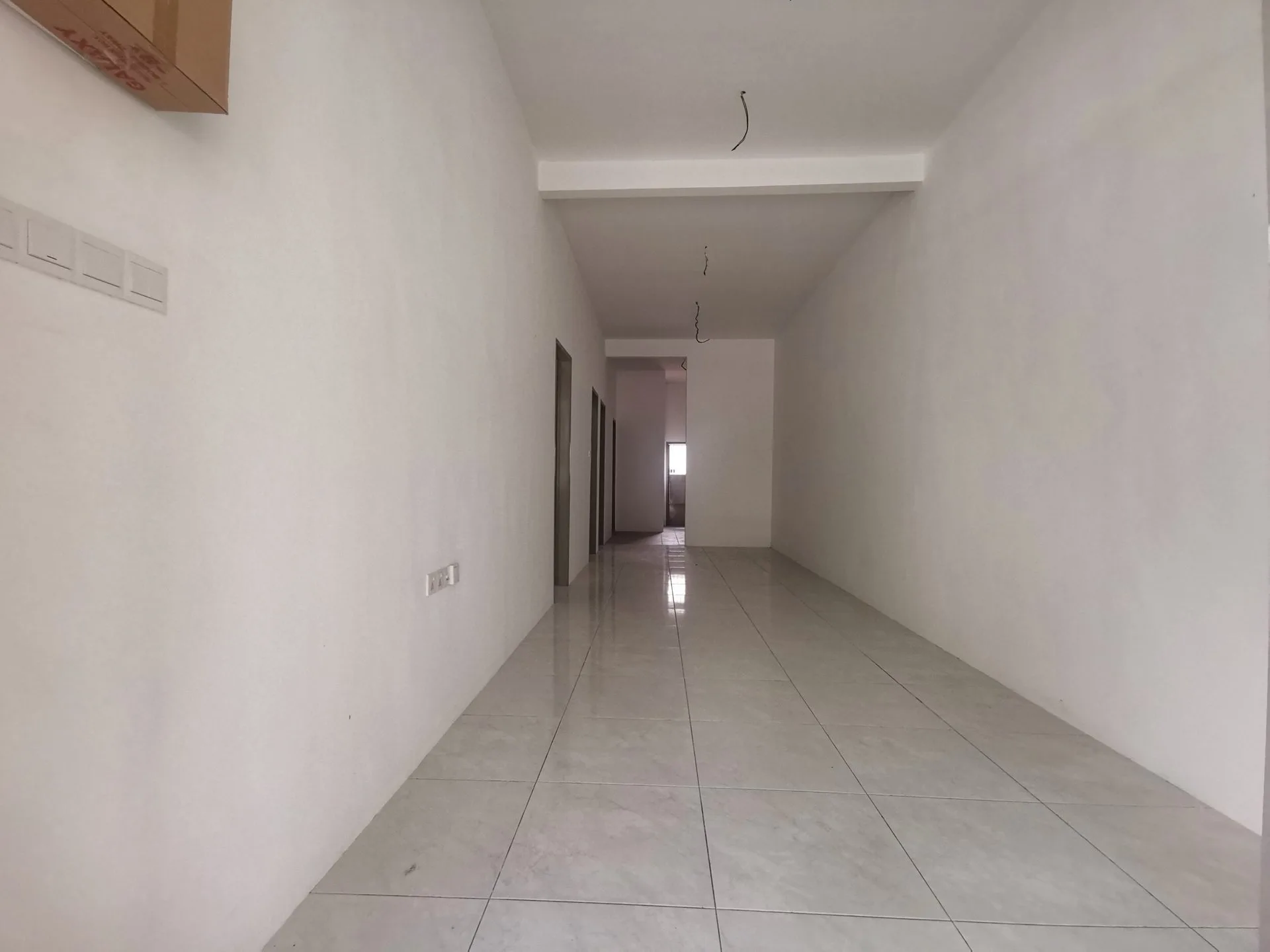 Interior of a completed bare unit with ceramic floor tiles at Taman Gopeng Mewah, Gopeng, Perak