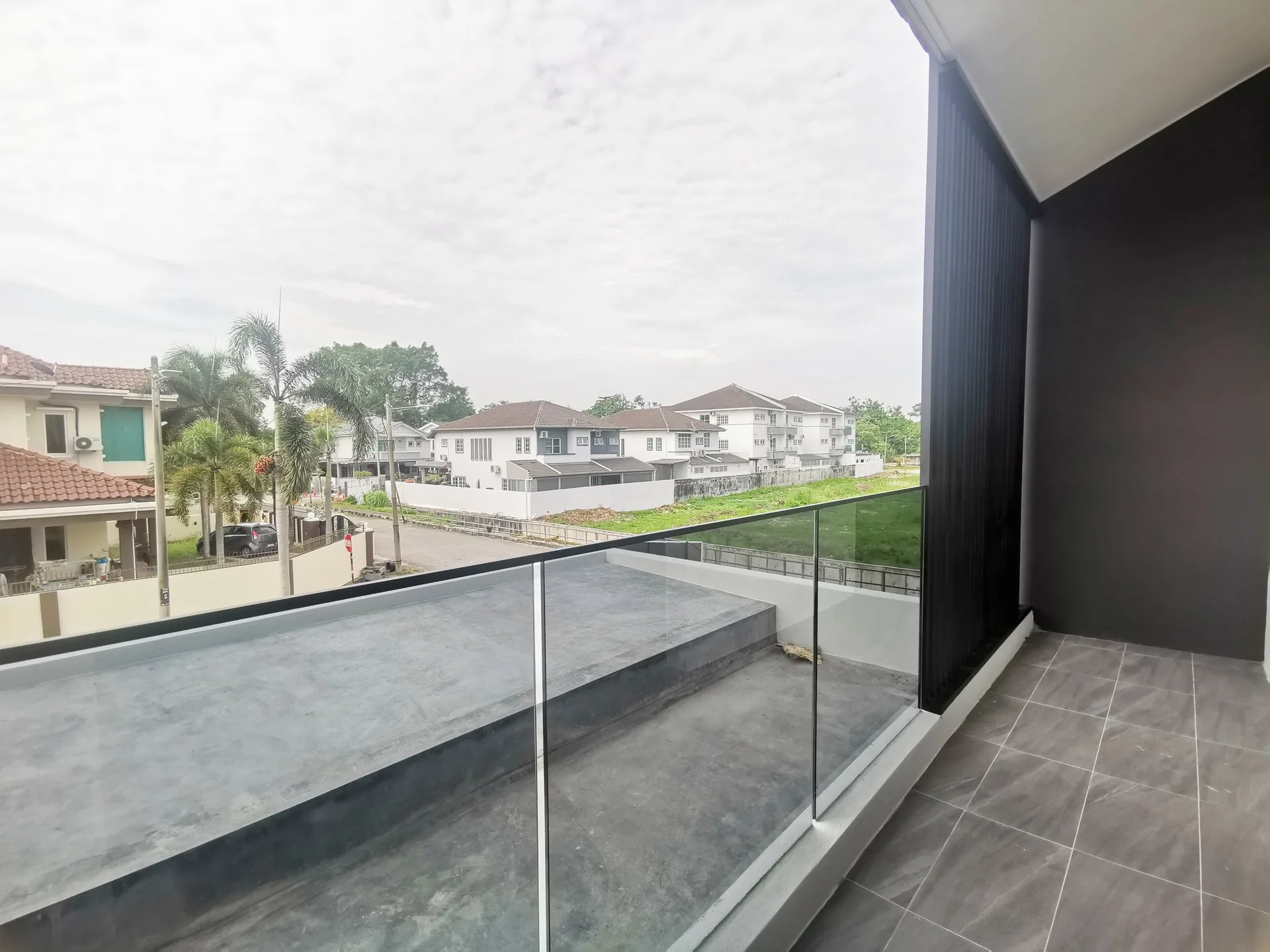 First-floor balcony with glass railing overlooking the street at The Aster @ Taman Sinfar by Constant Builder Sdn Bhd, Jalan Pasir Puteh, Ipoh, Perak