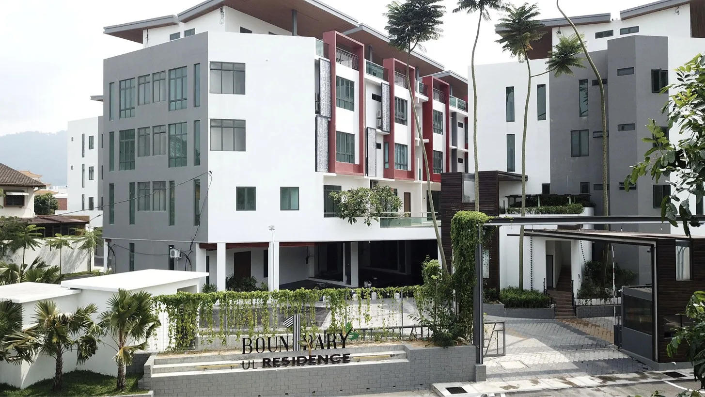 Photograph of the UL Residence entrance on Jalan Sempadan with the project sign, guard house and four-storey townhouses, Air Itam, Penang — from the developer's project page