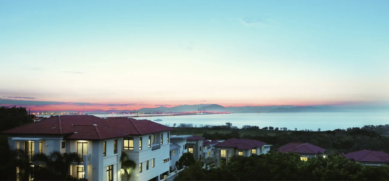 Dawn view over The Sanctuary estate across the channel towards the bridge, with the estate's bungalows in the foreground, Batu Uban, Penang